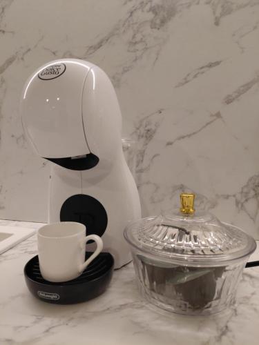 a coffee maker and a cup on a counter at Casa Maria in Żabbar
