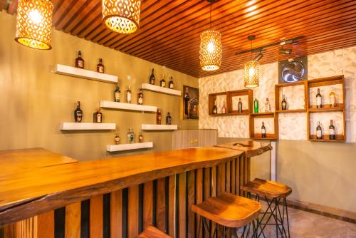 a bar in a restaurant with chairs and lights at Hotel La vena in Kampala