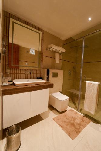 a bathroom with a toilet and a sink and a shower at Fortune Park Orange, Sidhrawali, Gurugram - Member ITC Hotels' Group in Bhiwadi