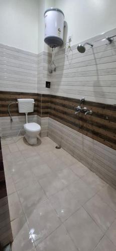 a bathroom with a toilet and a water tank at Keshav Homestay in Varanasi