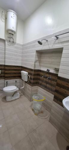 a bathroom with a toilet and a sink at Keshav Homestay in Varanasi