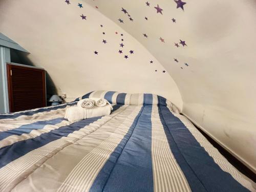 a bedroom with a bed with stars on the wall at The Blue Nest Suite - Sanremo in Sanremo