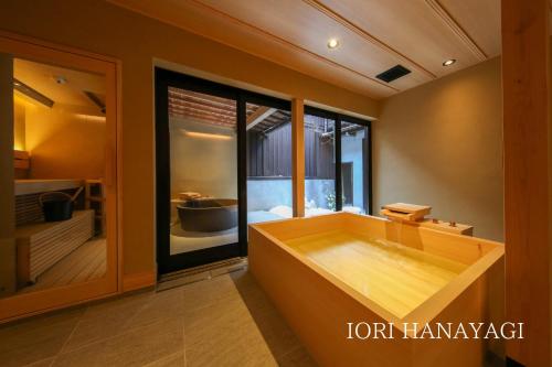 a bath tub in a room with a window at IORI Stay in Takayama