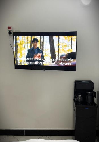 a flat screen tv hanging on a wall at Dana's Room in Dar es Salaam