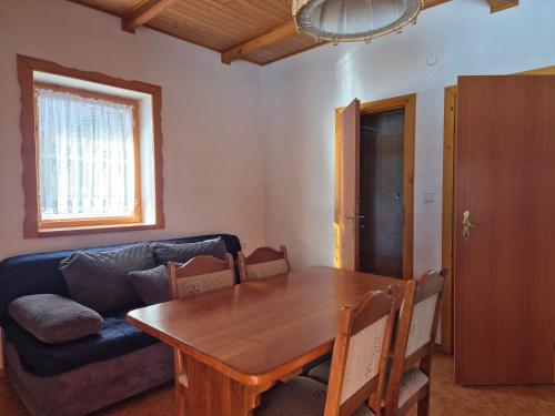 a living room with a table and a couch at Motýlek chata Sedmička in Borušov