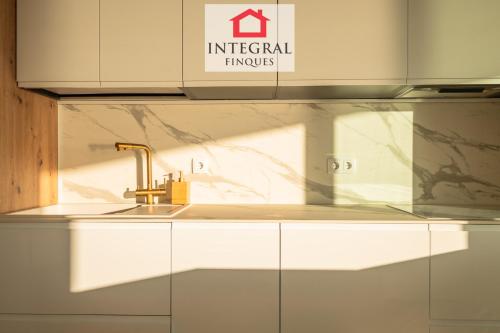 a kitchen with a sink and a counter top at Les Palmeres Palamós in Palamós