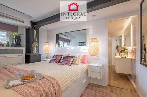 a bedroom with a bed with a tray of food on it at Les Palmeres Palamós in Palamós