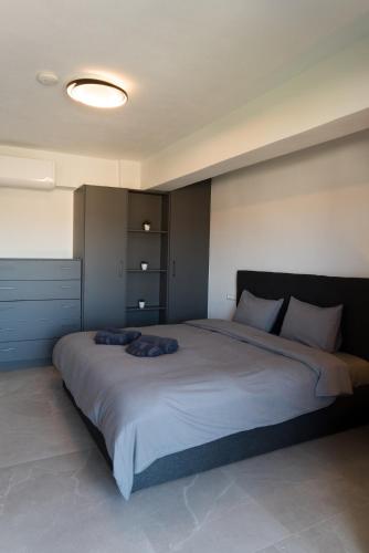 a bedroom with a large bed with two pillows on it at Signature city loft in Tríkala