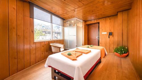 a bedroom with a large bed in a room with wooden walls at Yashshree Jai Hotel & Banquet in Darjeeling