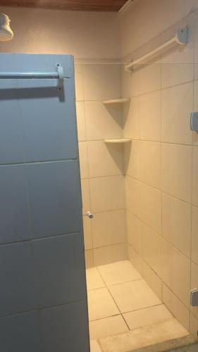 a bathroom with a shower with a glass door at Pousada Nascer do Sol in Marau