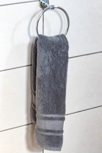 a grey towel hanging on a towel rack at The River Boutique Inn in Lobamba