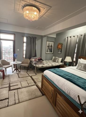 a bedroom with two beds and a chandelier at Karma homestay in Ravangla