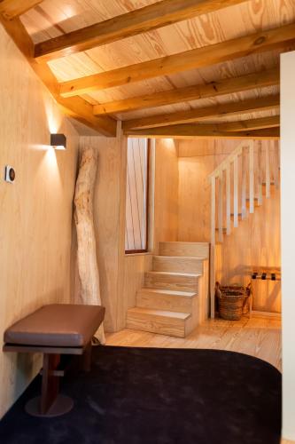 a room with stairs and a bench and a stair case at Torre de Gomariz Wine & Spa Hotel in Braga