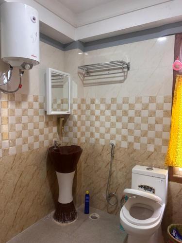 a bathroom with a toilet and a sink at Karma homestay in Ravangla
