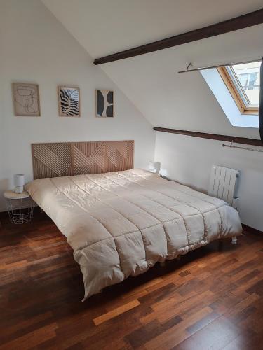 a bedroom with a large bed in a attic at Appart 3 sous combles in Bray-Dunes