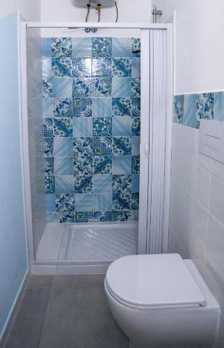 a bathroom with a toilet and a shower at B&B RoseMary in La Maddalena