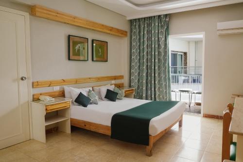 a hotel room with a bed and a balcony at Beau Site Hotel in Marsa Matruh