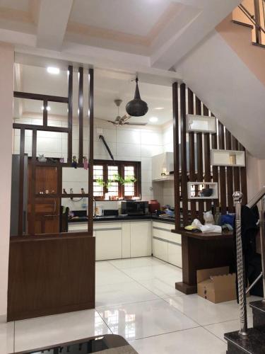 a large kitchen with a staircase in a room at Vadodara Homestay in Vadodara