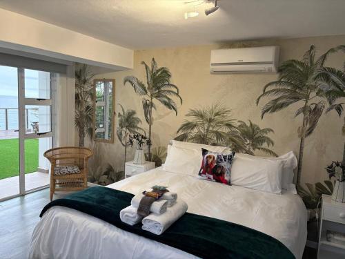 a bedroom with a bed with two stuffed animals on it at The Windsock in Ballito