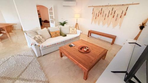 a living room with a couch and a coffee table at Oceanfront 2 bedrooms apartment with swimming pool & garage in Cascais