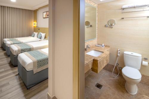 a hotel room with two beds and a sink at فندق عفراء in Mecca