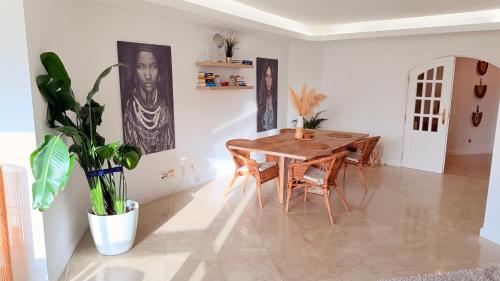 a dining room with a wooden table and chairs at Oceanfront 2 bedrooms apartment with swimming pool & garage in Cascais