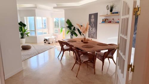 a dining room with a wooden table and chairs at Oceanfront 2 bedrooms apartment with swimming pool & garage in Cascais