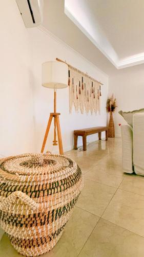 a living room with a chair and a table at Oceanfront 2 bedrooms apartment with swimming pool & garage in Cascais