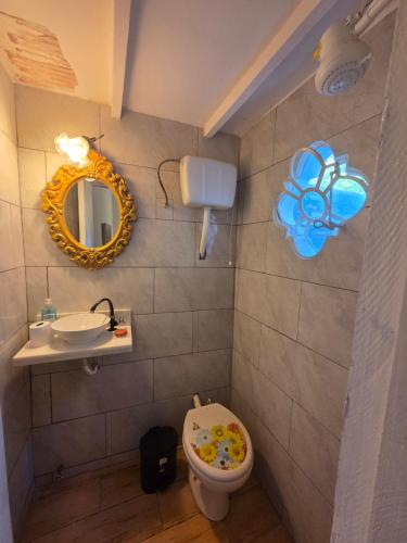a bathroom with a toilet and a mirror and a sink at Los Prados Sanber in San Bernardino
