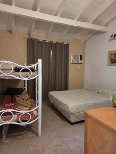 a bedroom with two bunk beds in a room at Los Prados Sanber in San Bernardino