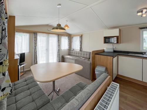 a living room with a couch and a table at Peppy in Newton Stewart