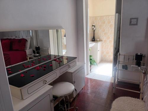 a room with a table with a large mirror at Crocodile Rock Lodge in Bulawayo