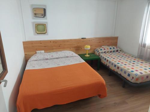 a small room with two beds and a table at Apartment Núria in Bellreguart