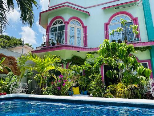 a house with a swimming pool in front of it at The Quetzal in Cancún