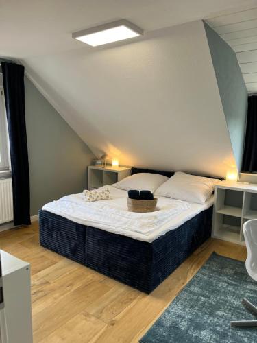 a bedroom with a large bed in a attic at Ferienwohnung Benz in Löningen