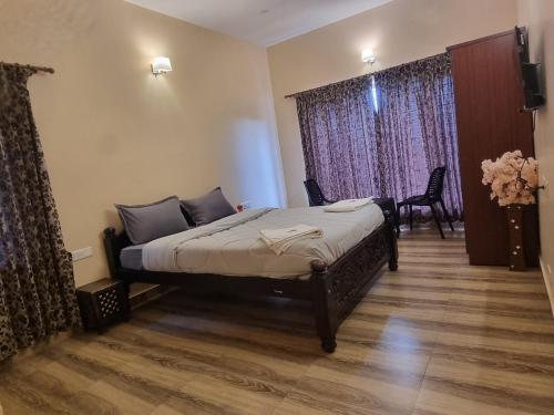 a bedroom with a bed in a room at Honey Bee Cottages in Ooty