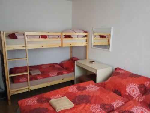 a room with two bunk beds and a bed at Bungalov Mikulášovice in Mikulášovice