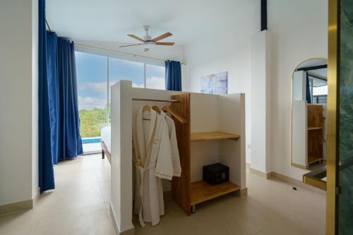a dressing room with a closet and a window at Aura Koh Tao in Ko Tao