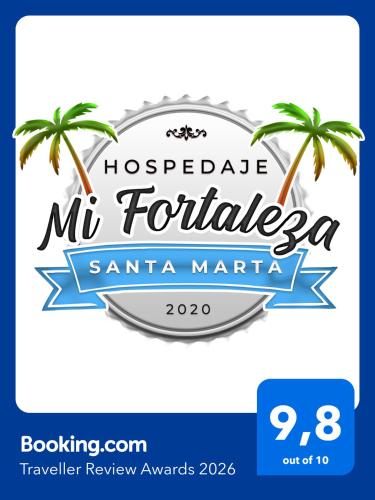 a sign for a hotel with two palm trees at Hospedaje Mi Fortaleza, Con Piscina, Parqueadero y estamos a 10 Minutos Caminando a Playa Dormida, 5 Minutos del Aeropuerto y a 15 Del Rodadero en Bus in Santa Marta