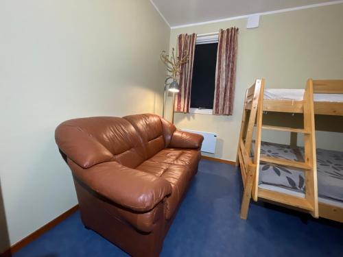 a living room with a couch and a bunk bed at Laplanders room 3 in Kiruna