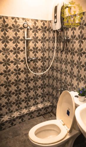 a bathroom with a toilet and a shower at Green Shade Resort & Haritha Sewana Hotel in Nallathanniya