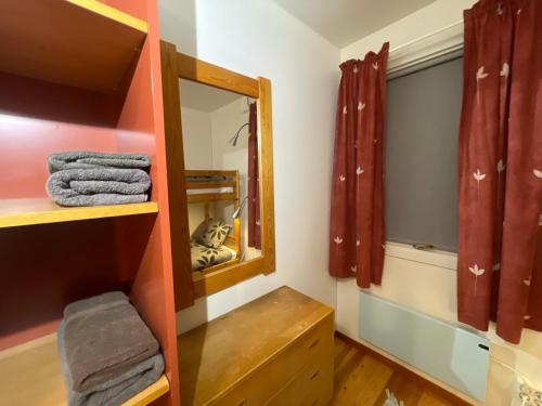 a bathroom with a mirror and a wooden shelf at Laplanders room 2 in Kiruna
