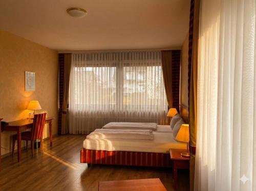 a hotel room with a bed and a window at Hotel Hebelhof in Bad Bellingen
