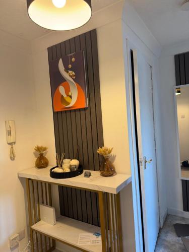 a room with a table with a picture on the wall at Nessy5 Apartment in Inverness