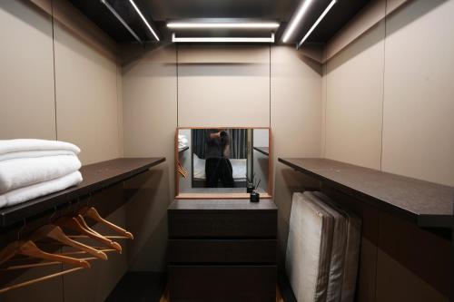 a dressing room with a mirror and a person in the reflection at 서초 아트하우스2 in Seoul