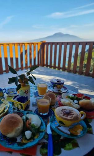 a table with plates of food and drinks on it at La Palombara B&B in Vico Equense
