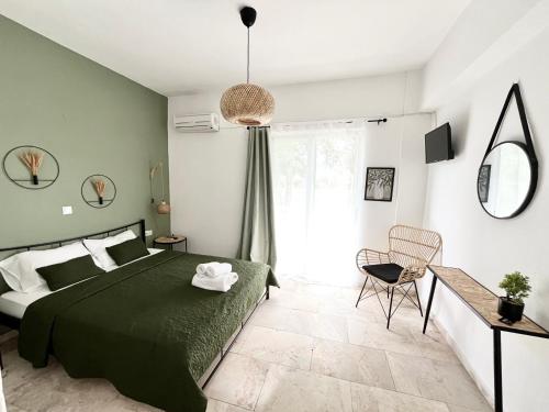 a bedroom with a green bed and a chair at LaMar in Skala Prinou