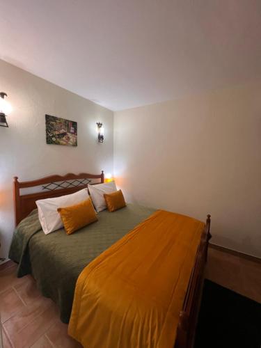 a bedroom with a bed with two pillows on it at Quinta dos Viegas in Faro