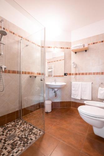 a bathroom with a toilet and a sink at Garnì dal Mozat in Ledro