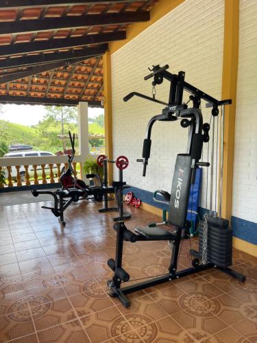 a gym with two tread machines in a room at Fascinação Café Hotel in Cunha